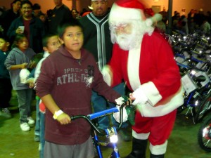 Santa Claus presents a bike / photo by Daniel Buckley