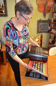 Surprise, Arizona's Alicia Sterna, shown leafing through a book of her art quilts, has been a lawyer and a former park ranger.