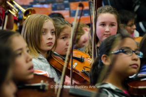 Students of Tucson's Davis Elementary School's Mariachi Las Aguilitas watch director Jaime Valenzuela for cues.